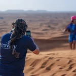 Trawey private guide taking photos for a guest during a personalized private desert safari in Dubai.