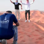 Trawey Tours guide providing a private desert photography session for a group during a sunrise safari in Dubai.